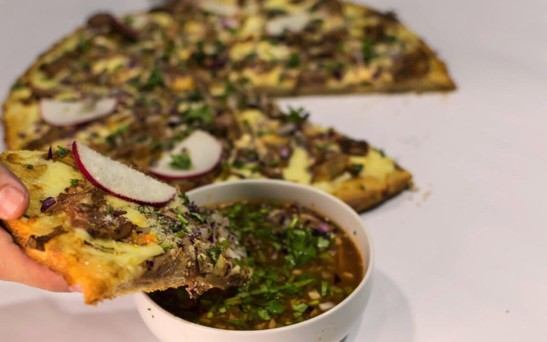 Birria Pizza: savory slices dipped in delicious consomé